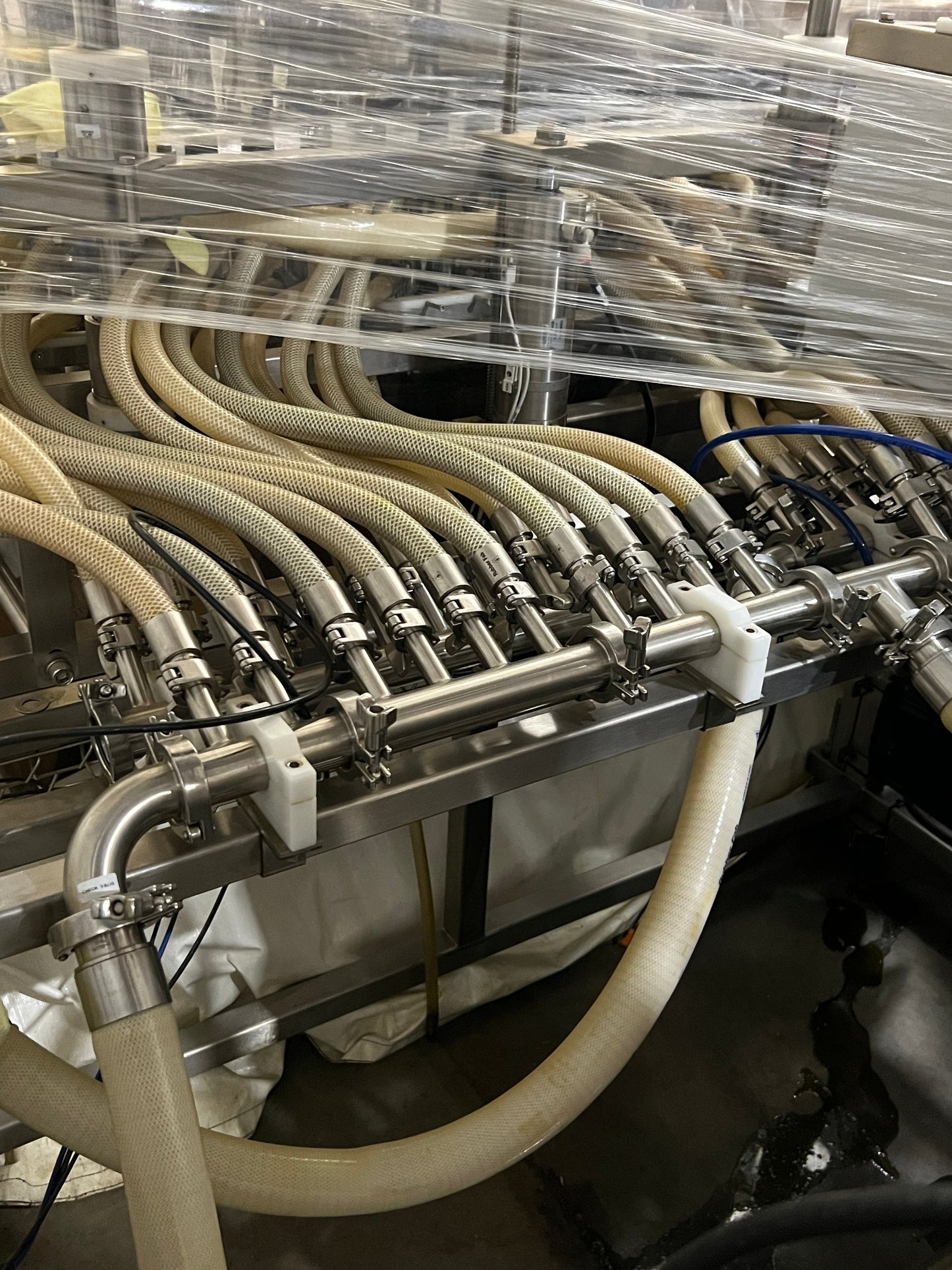 Slightly Used Inline Filling Systems - Overflow Filler - 16-20 Head Pressure overflow hot filler, with feed tank, Serial # 46910, 220 Volt