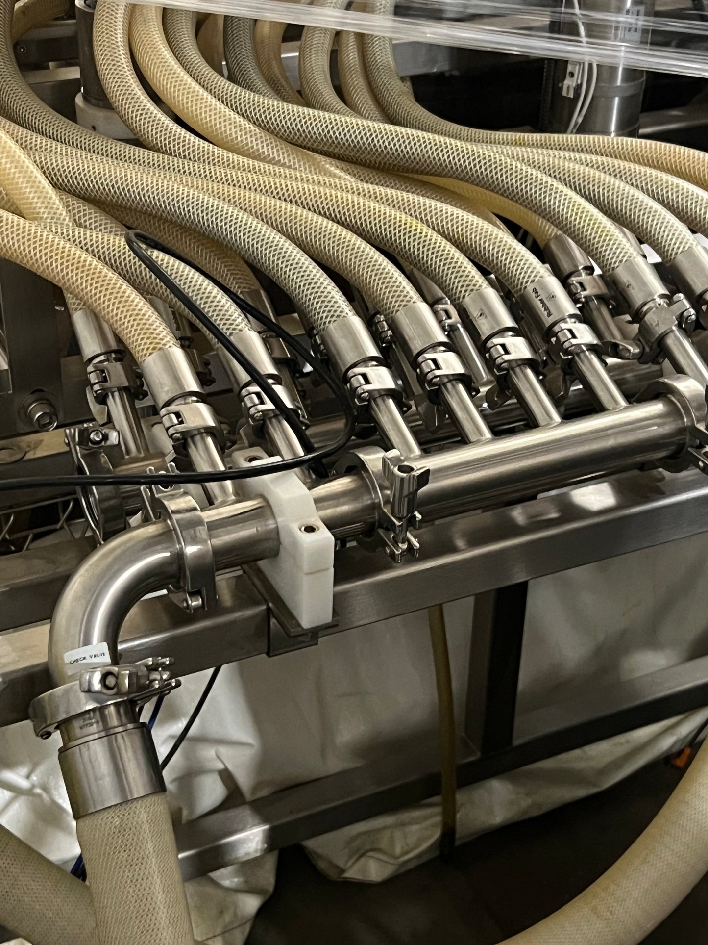 Slightly Used Inline Filling Systems - Overflow Filler - 16-20 Head Pressure overflow hot filler, with feed tank, Serial # 46910, 220 Volt