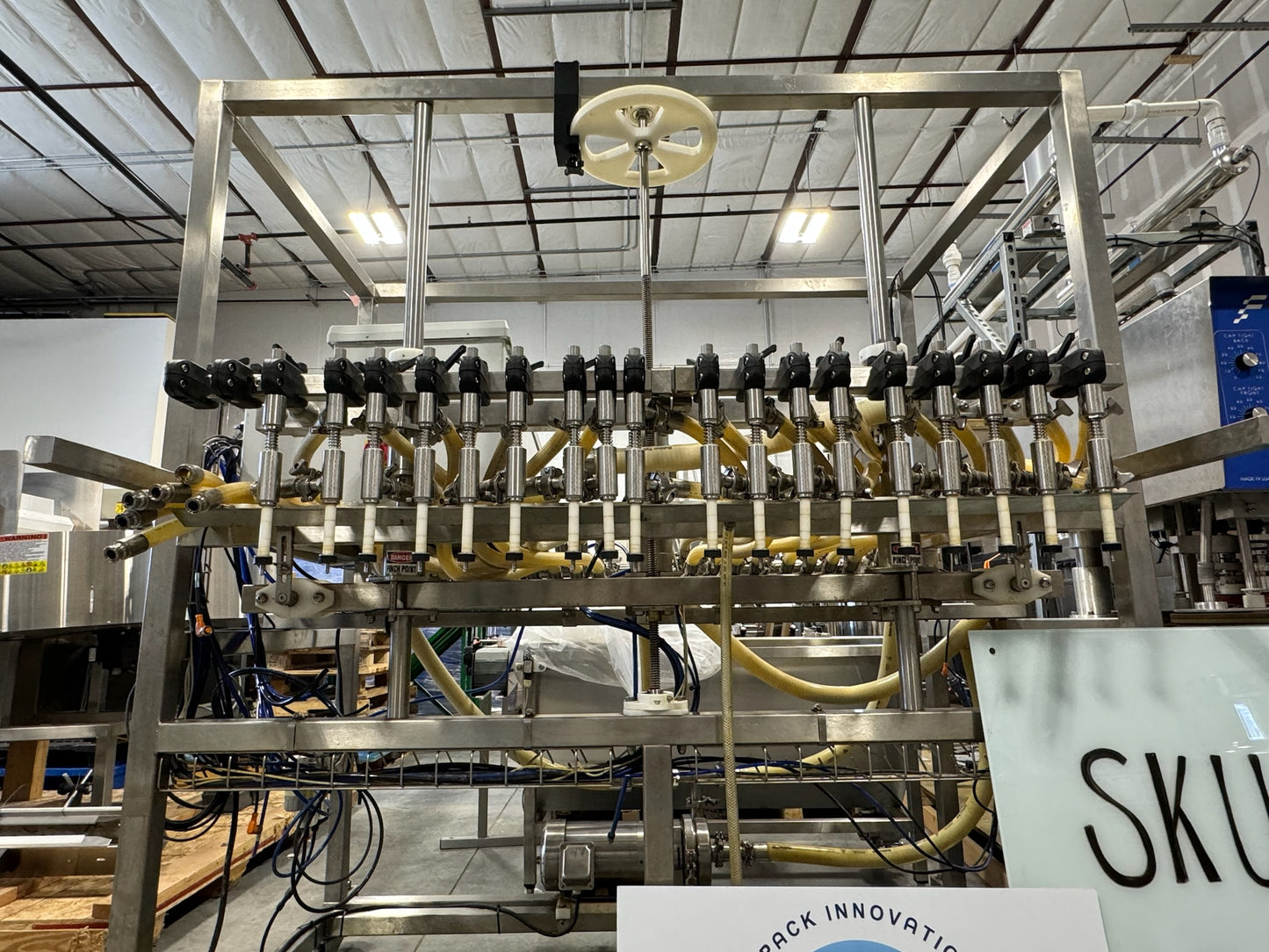 Slightly Used Inline Filling Systems - Overflow Filler - 16-20 Head Pressure overflow hot filler, with feed tank, Serial # 46910, 220 Volt